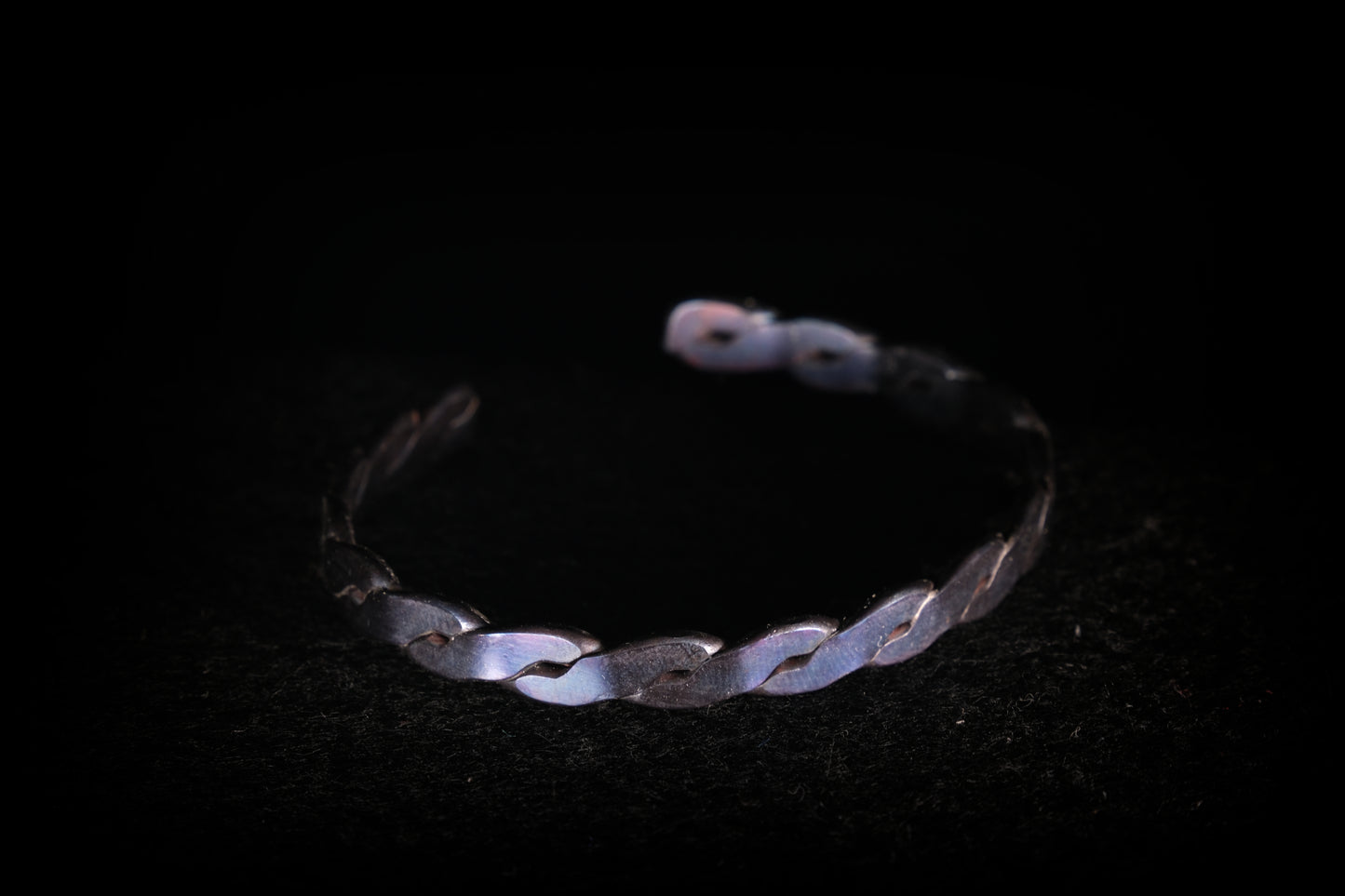 Silver bracelet on a black background