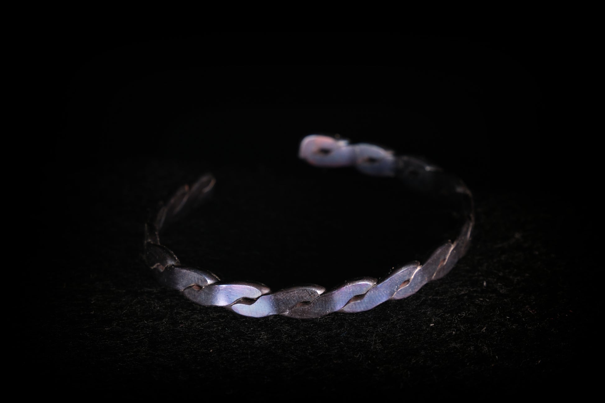 Silver bracelet on a black background