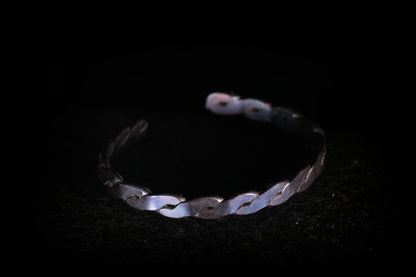 Silver bracelet on a black background